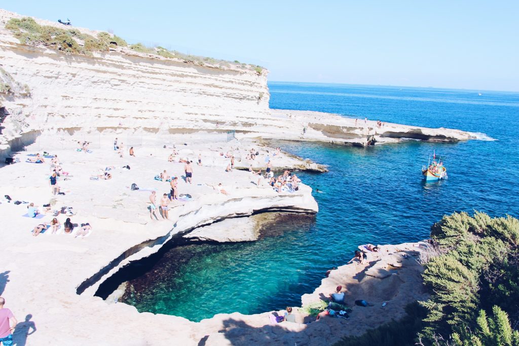 what to do in malta: rocks and blue water at St Peter's Pool