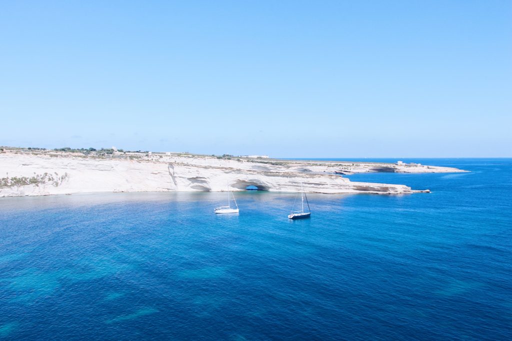 view of cliffs, boats and blue ocean